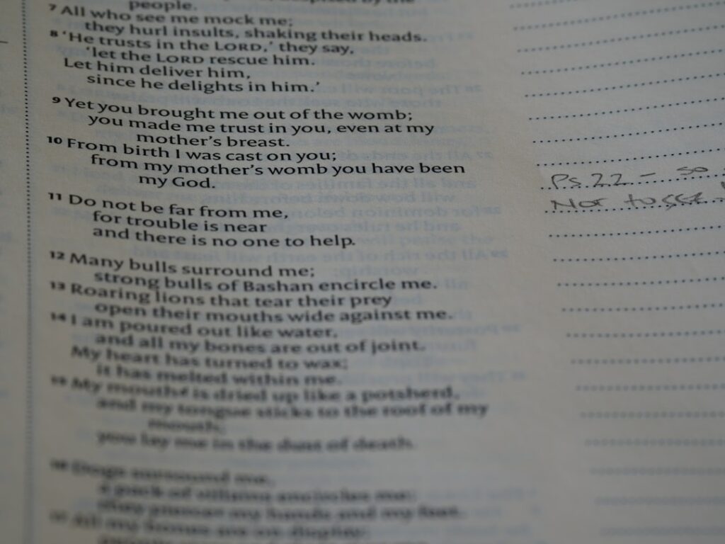 A teacher and students discussing poetry with open notebooks on a classroom table.